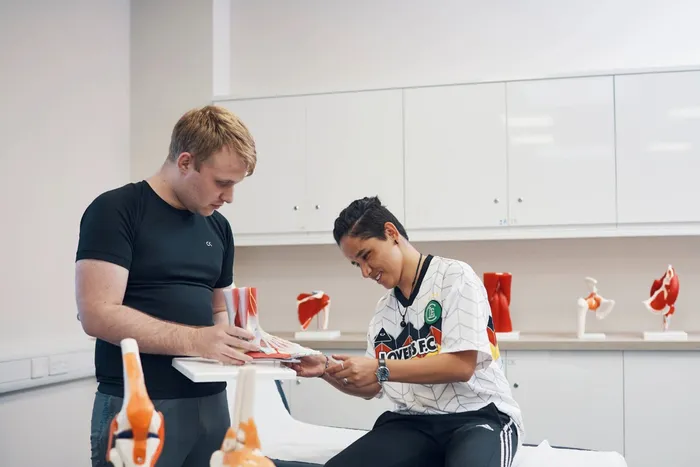 Two students working in our Sports Science Laboratory on Main Campus