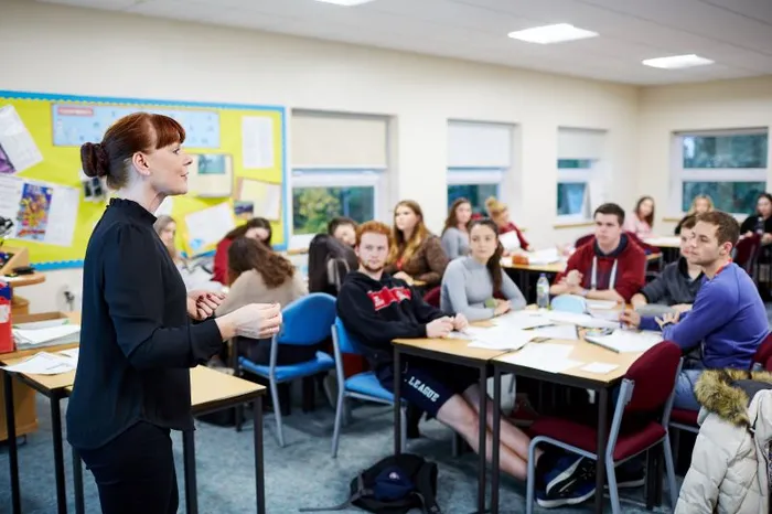 Image of Education lecturer with students.