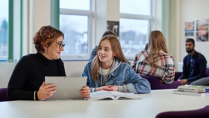 A lecturer and a student in the classroom.