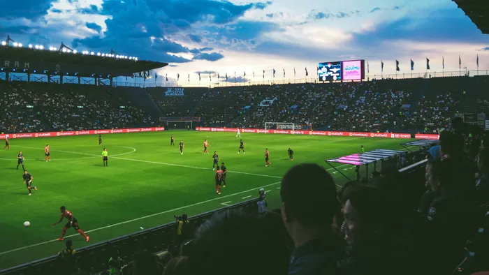 A football match seen from the audience stalls.