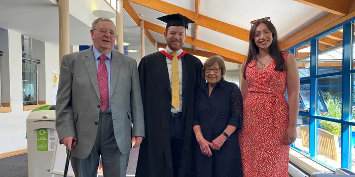 Student celebrating graduation with his family