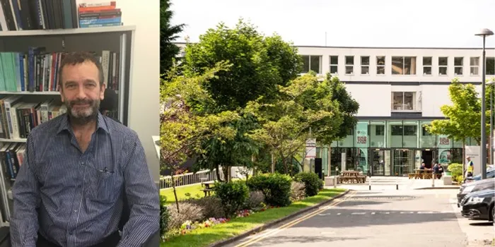 man on the left looking at camera. University building to the right