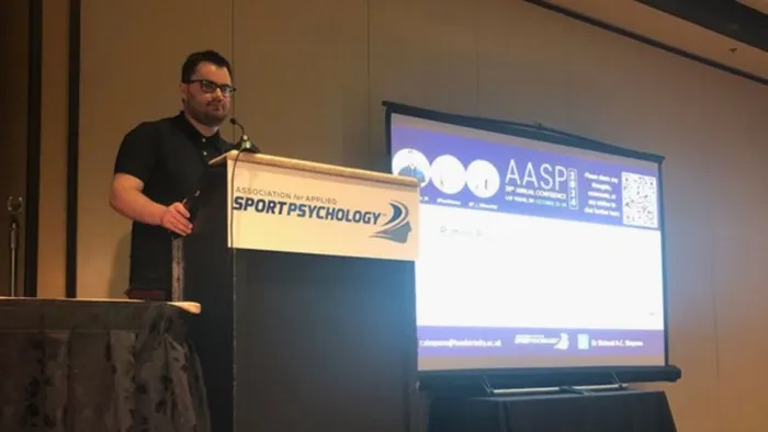 A man stands behind a lectern while delivering a speech
