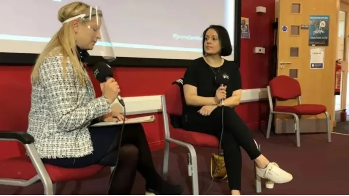 Two females discussing Public relations