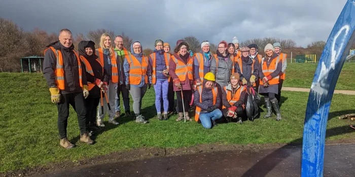 People pose for a group picture in a park