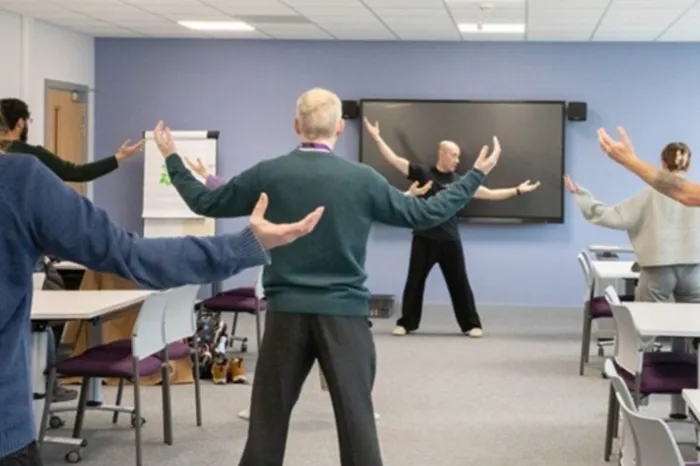 Colleagues from the School of Psychology take part in a Tai Chi session