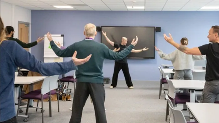 Colleagues from the School of Psychology take part in a Tai Chi session