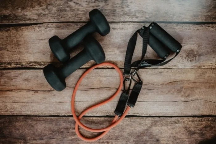 Gym equipment including dumbbells and skipping rope