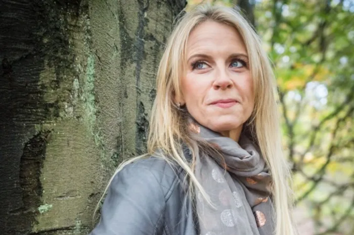 Jane Browne leaning against a tree