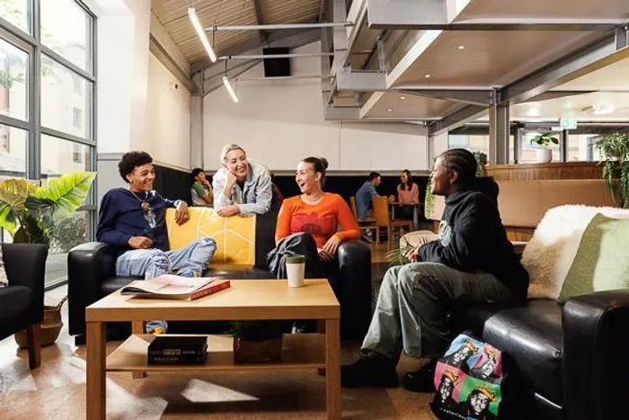 students relaxing in Clarence Dock Village Common Room