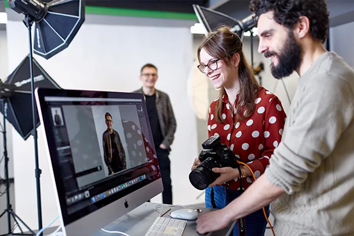 Student being taught how to use photography studio 