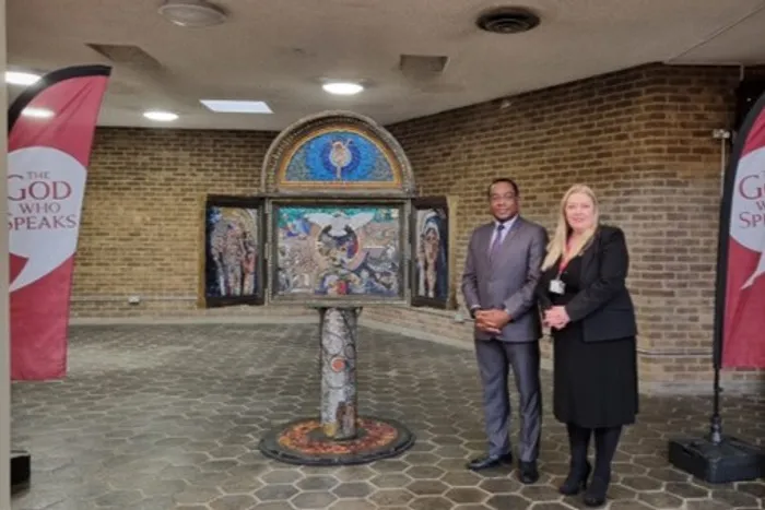 Charles Egbu and Ann Marie Mealey stood next to the 'Little Bits of God' Mosaic