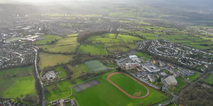 Aerial image of green spaces, buildings, sports field