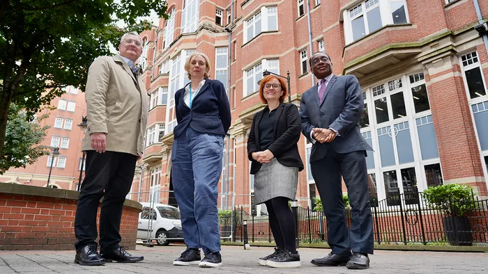 Four people outside the Leeds Trinity University City Campus.