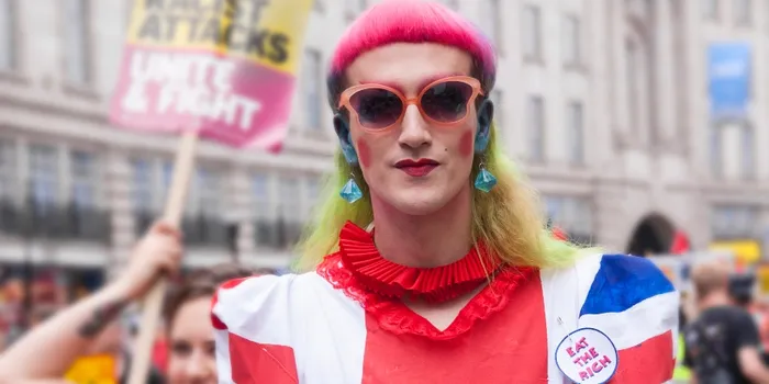 White protestor in orange clothes and sungalsses