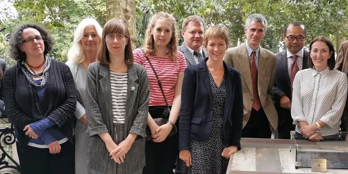 A group shot of researchers next to a table