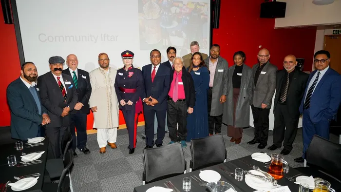 Attendees at a community Iftar hosted by Leeds Trinity University pose for a picture