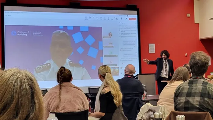 A man speaks to the audience at the Policing Conference