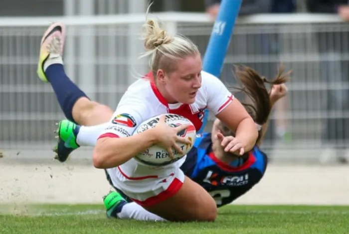 Charlotte Booth playing rugby