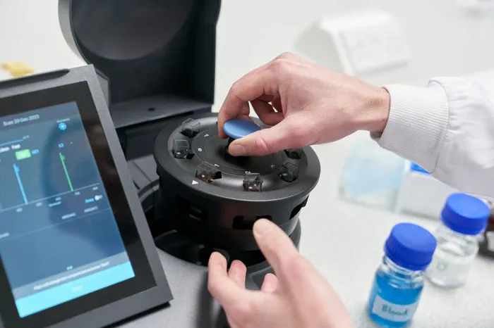 Loading a carousel into a spectrophotometer.