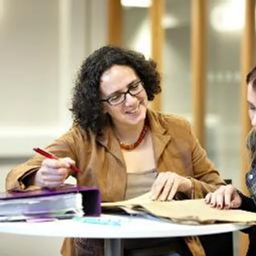 Professor Karen Sayer writing at a desk