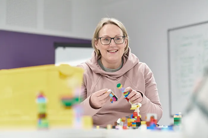 Teacher or CYPF student working with building blocks