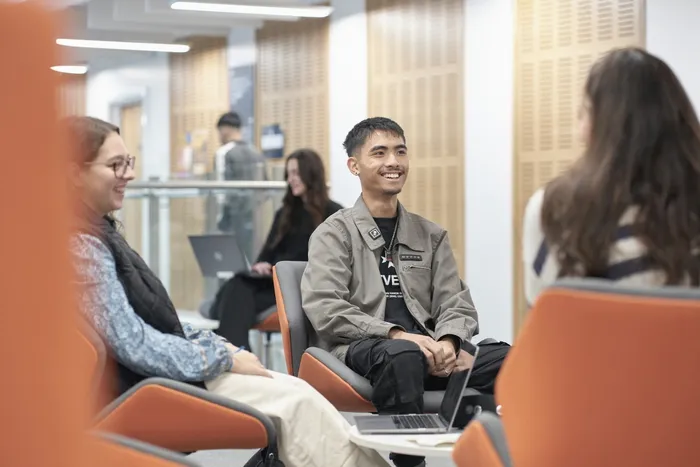Students chatting and studying in the Andrew Kean Learning Centre.