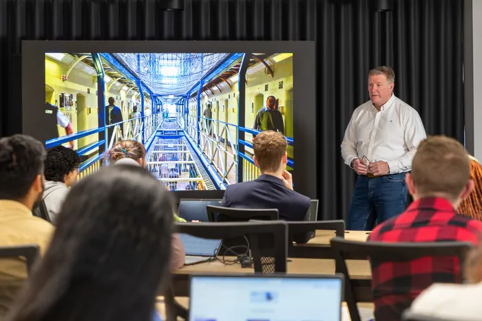 Criminology and Policing Lecturer giving a presentation in Leeds City Campus lecture theatre.