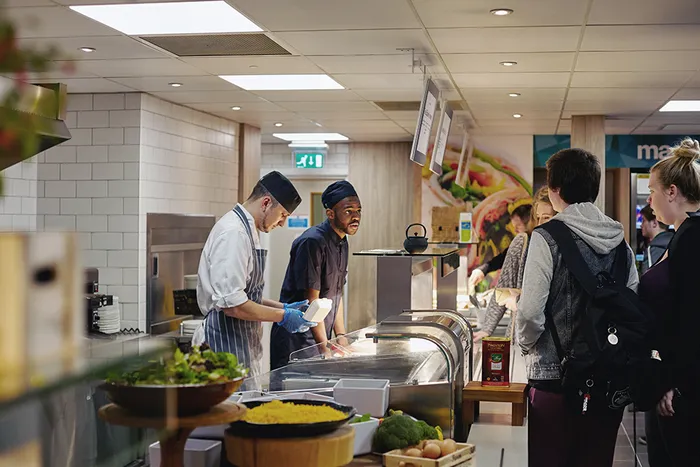 Students queue up for food in the dining room on Main Campus