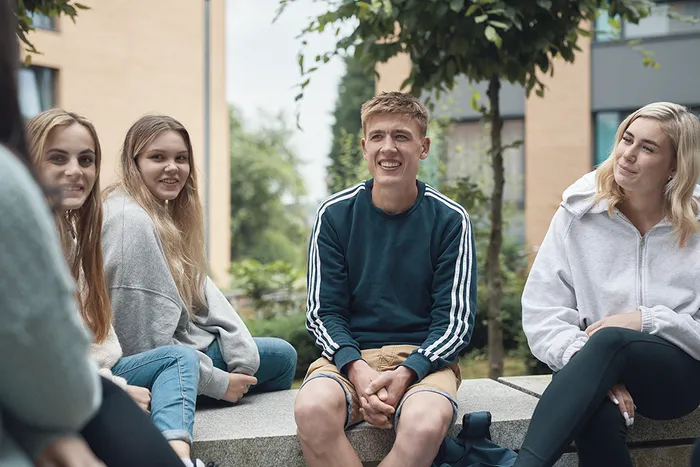 Group of students sit outside on Main Campus in Horsforth
