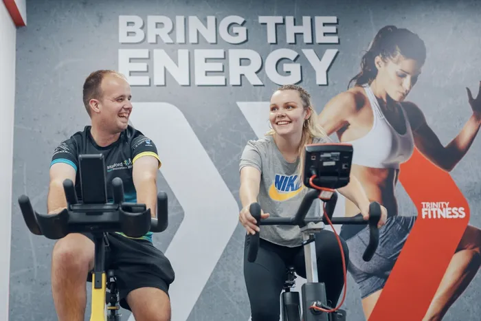 Students using gym equipment in Trinity Fitness.