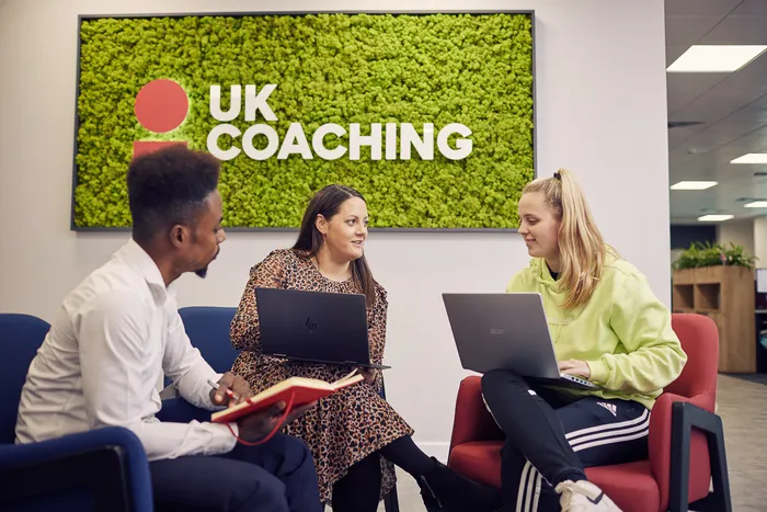 Two students sat talking with their placement provider