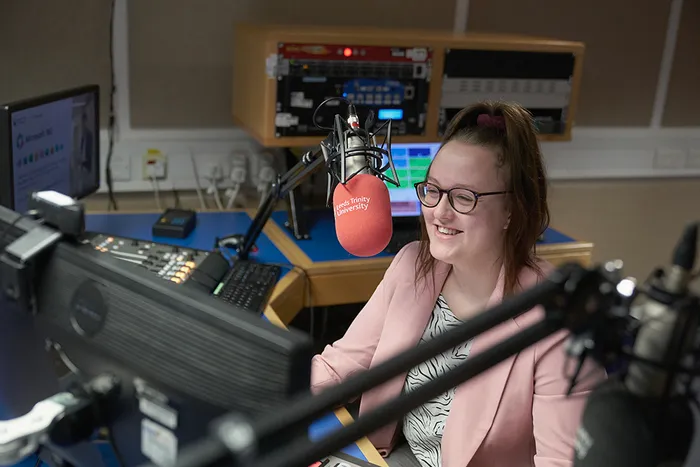 Journalism student records in the radio studio