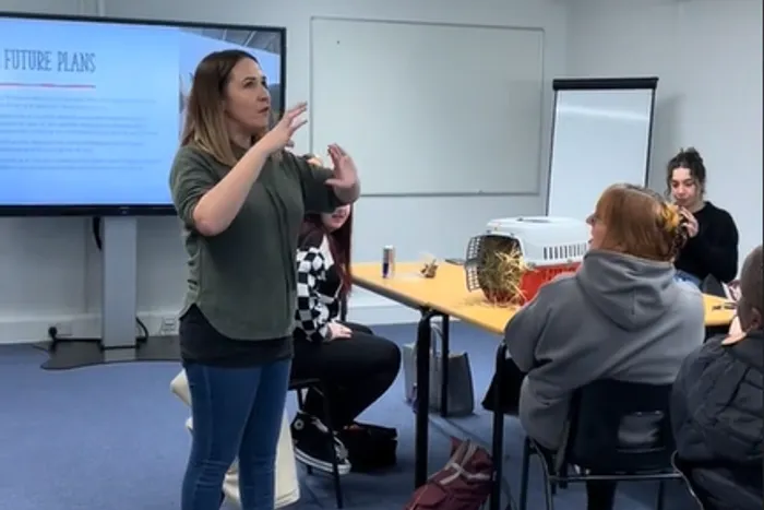 Image of alumna Becca Haigh speaking to CYPF students.