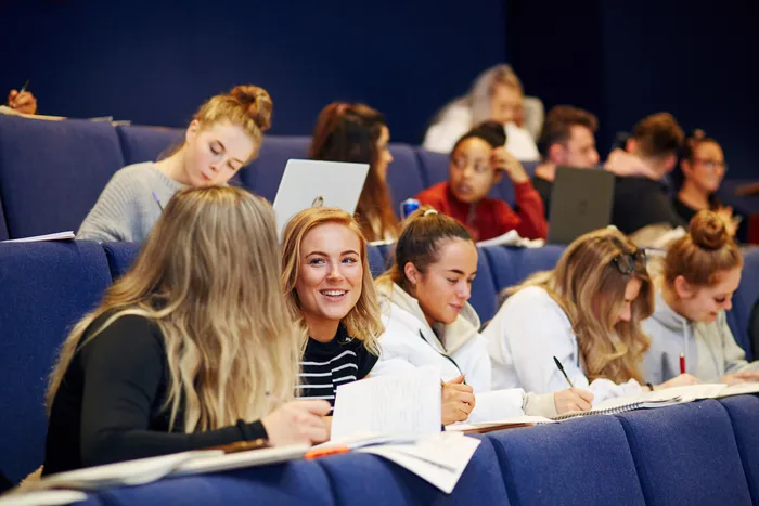 Students learning in a lecture theatre.