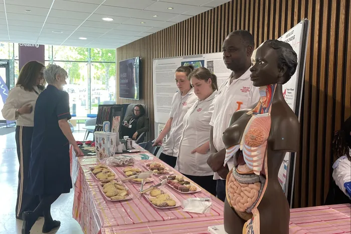 Nursing Associate Apprentices next to the organ game.